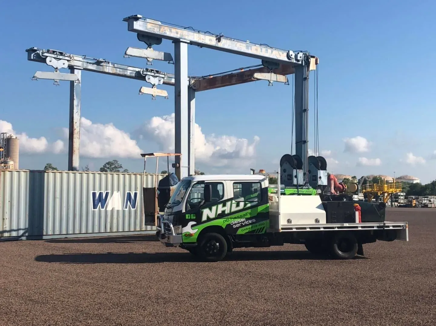 NHDS crew cab truck under a port gantry crane